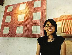 Low with two of her oil-on-canvas pieces in the background - Zinc I (left) and Zinc II - which accentuate the artist's love for straight lines and geometrical shapes.